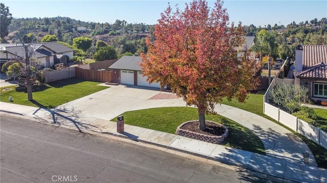 view of front of home featuring a front yard and a garage