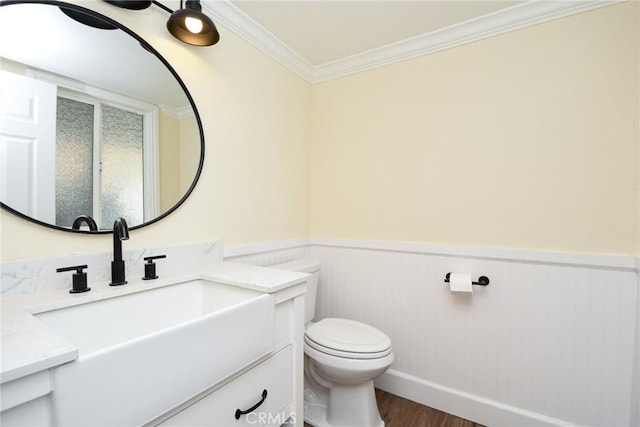 bathroom featuring vanity, toilet, wood-type flooring, and crown molding