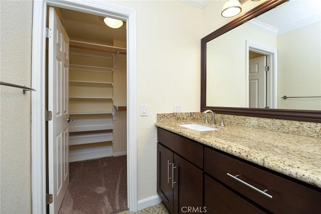 bathroom featuring crown molding and vanity