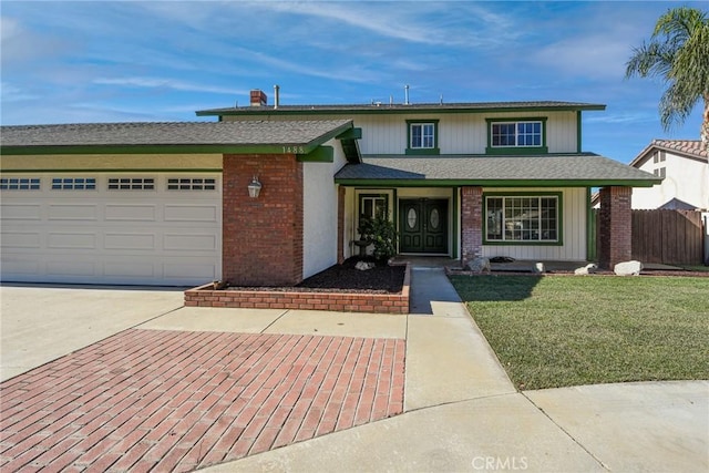 view of front of property featuring a garage and a front yard