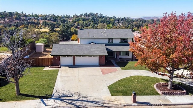 view of front of property featuring a garage and a front lawn