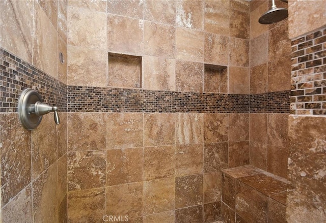 interior details with a tile shower