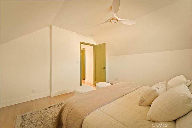 bedroom featuring hardwood / wood-style flooring, vaulted ceiling, and ceiling fan