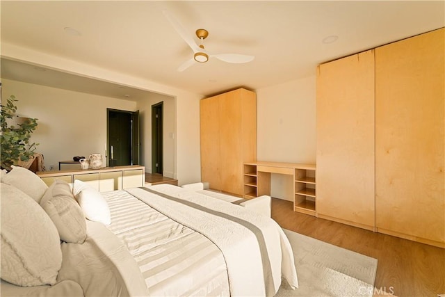 bedroom with ceiling fan and light wood-type flooring