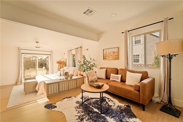 living area with plenty of natural light and light wood-type flooring