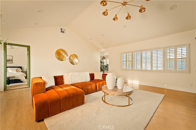 living room featuring lofted ceiling and light hardwood / wood-style flooring