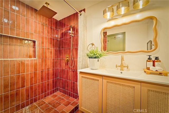 bathroom with vanity and a tile shower