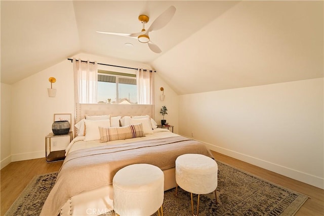 bedroom featuring hardwood / wood-style flooring, vaulted ceiling, and ceiling fan