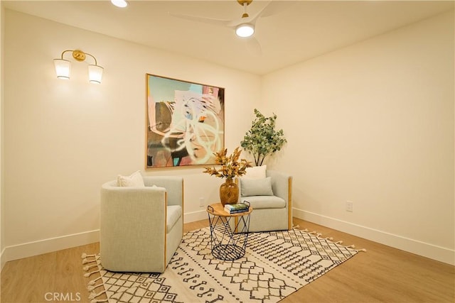 sitting room featuring ceiling fan and light hardwood / wood-style flooring