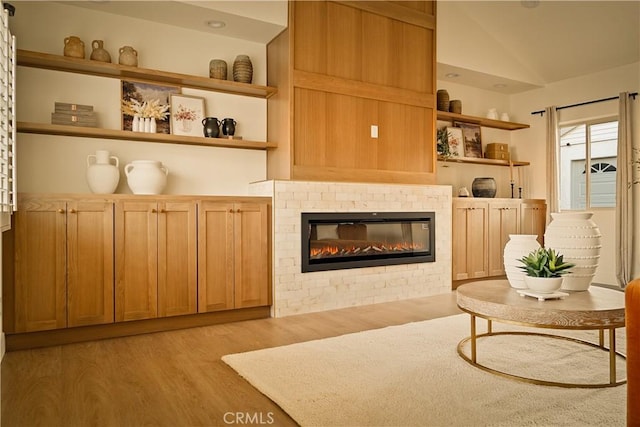 sitting room featuring lofted ceiling and light wood-type flooring