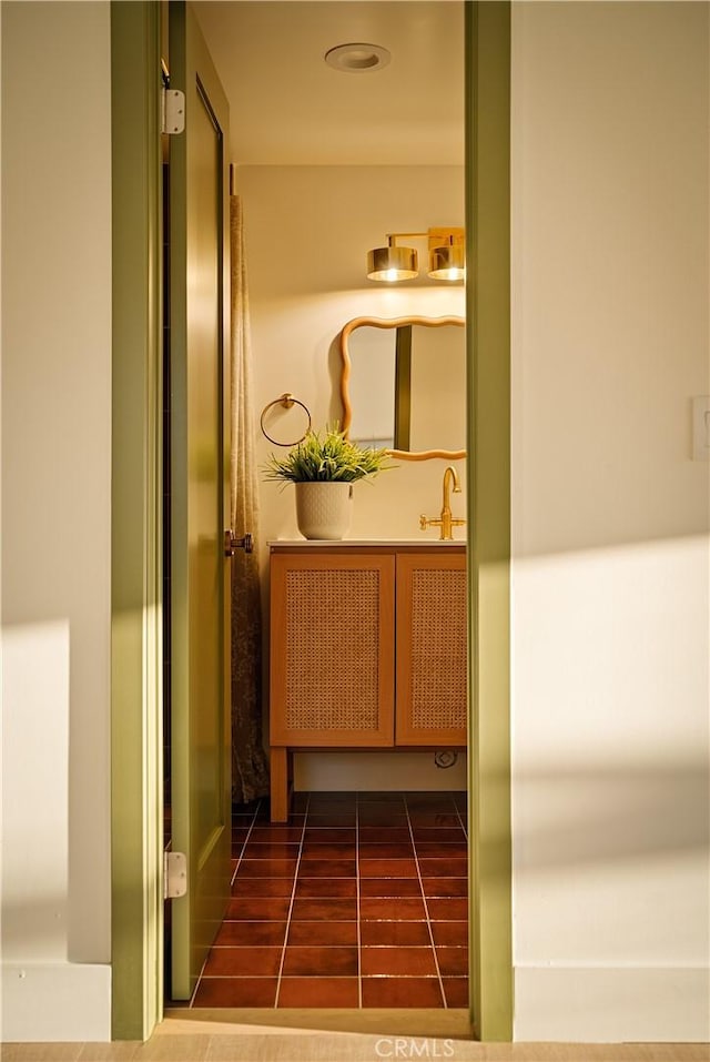 hall featuring dark tile patterned floors