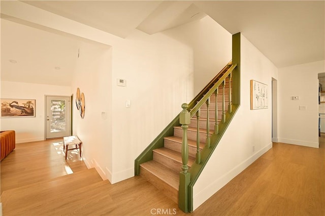 stairs featuring hardwood / wood-style flooring