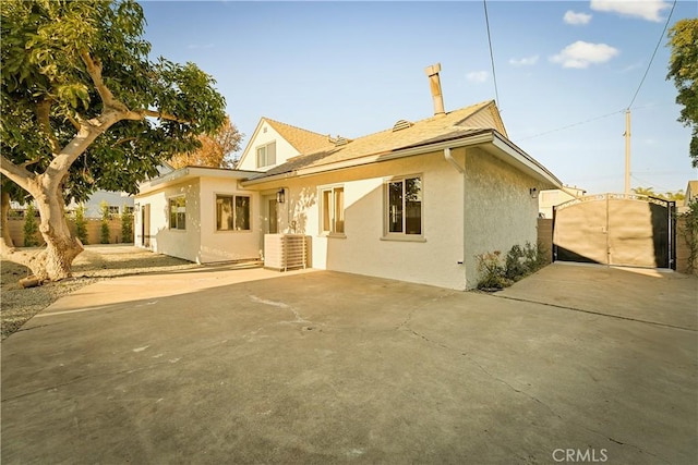 rear view of house featuring a patio and central air condition unit