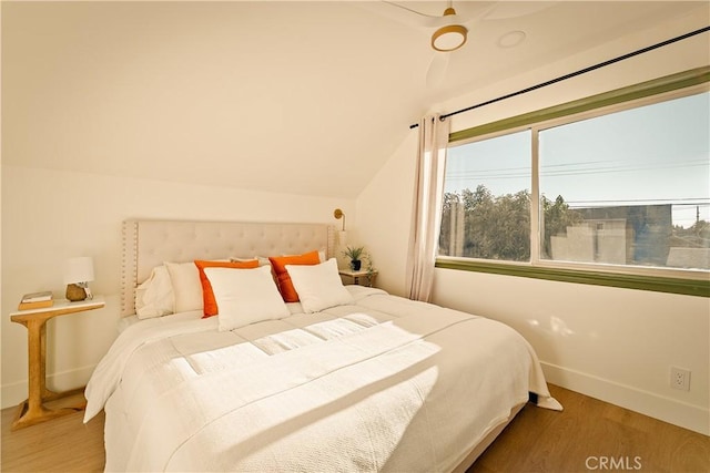 bedroom with lofted ceiling and hardwood / wood-style floors