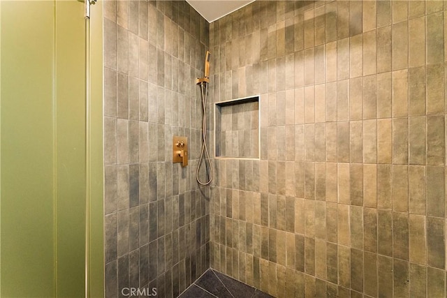 bathroom with a tile shower