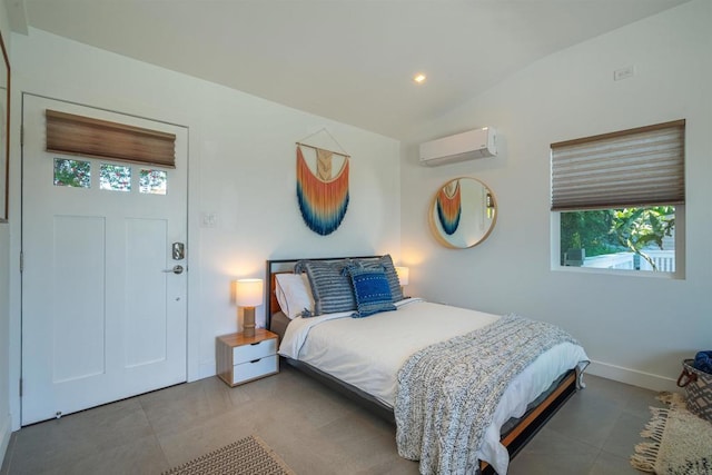 bedroom with a wall unit AC, multiple windows, and lofted ceiling