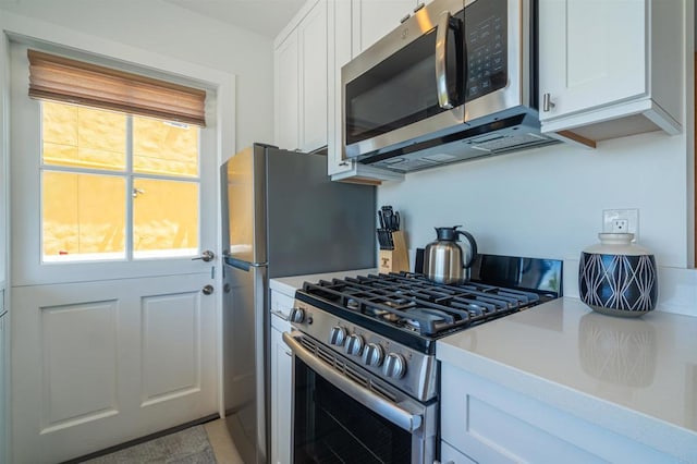 kitchen featuring white cabinetry and appliances with stainless steel finishes