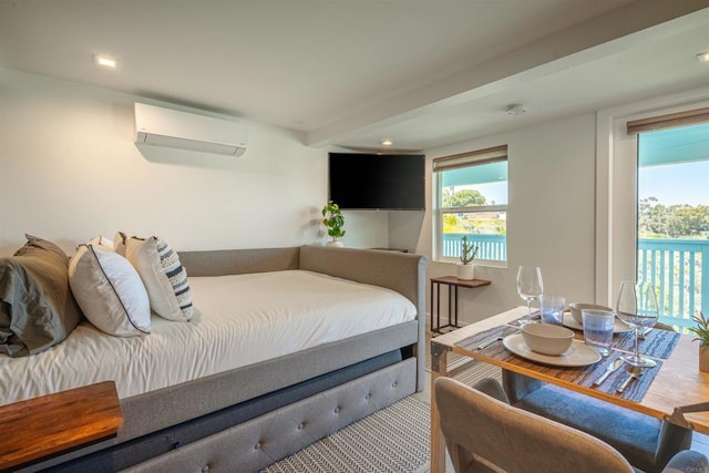 bedroom featuring a wall unit AC, access to exterior, and beamed ceiling