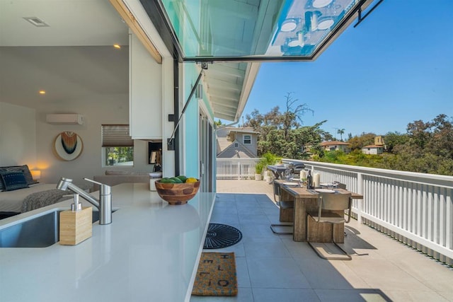 view of patio featuring a wall unit AC and sink