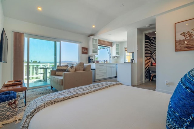 bedroom with access to exterior, hardwood / wood-style floors, multiple windows, and lofted ceiling