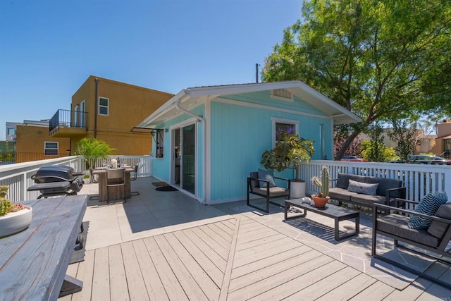 deck featuring outdoor lounge area, a grill, and a patio area