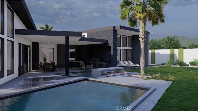 view of pool with a mountain view, a yard, an outdoor hangout area, and a patio area