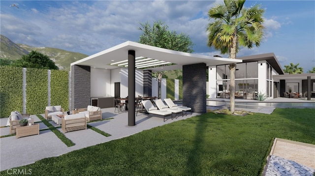 rear view of house with outdoor lounge area, a mountain view, a yard, and a patio