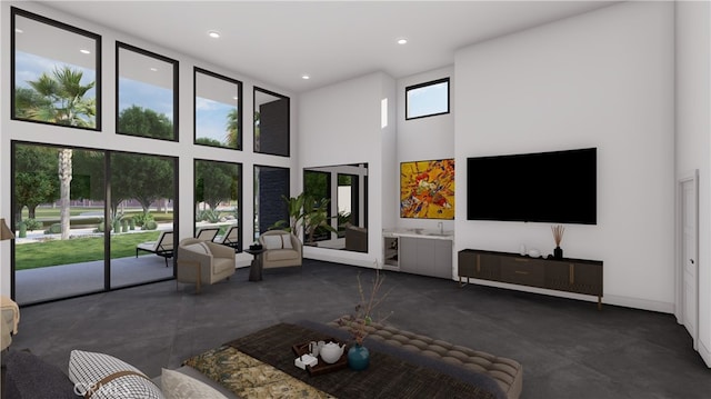 unfurnished living room featuring a wealth of natural light and a towering ceiling