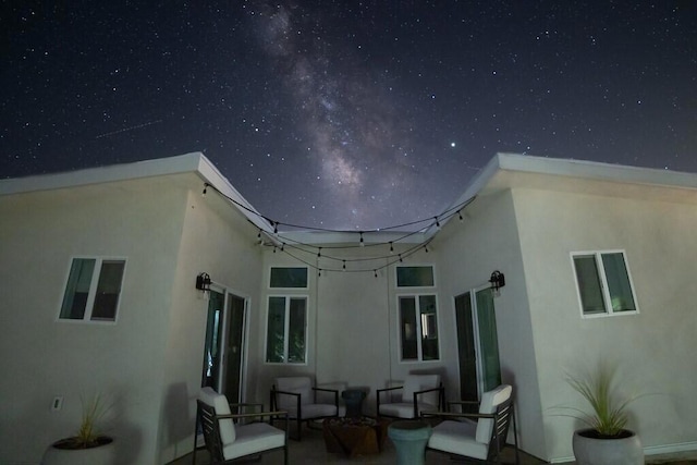 back of property with an outdoor hangout area