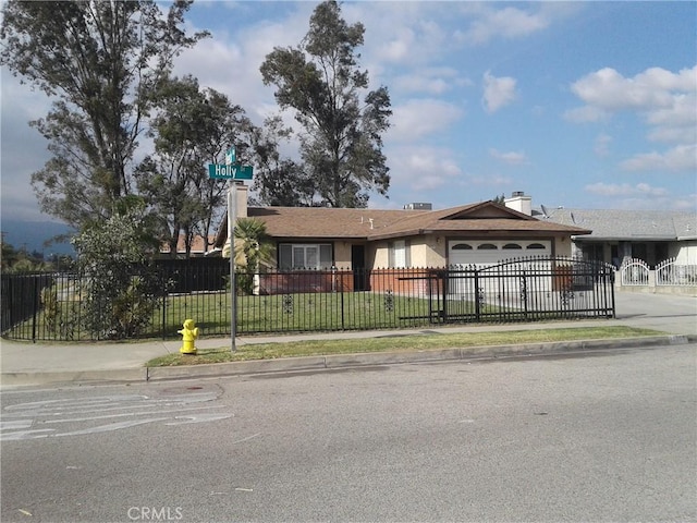 ranch-style home featuring a garage and a front yard