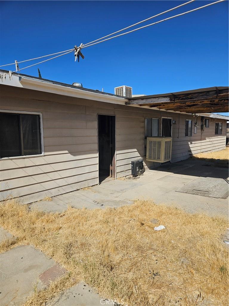 back of property featuring a patio and central AC