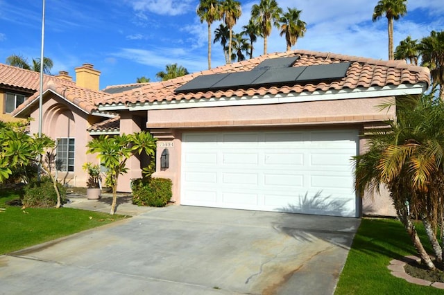 mediterranean / spanish-style home with a garage