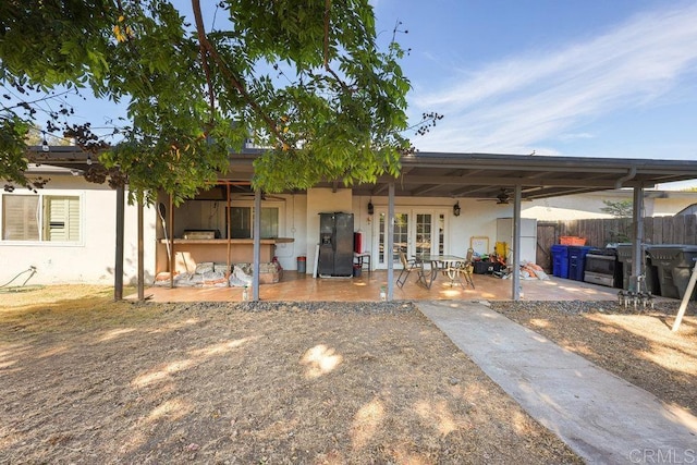 rear view of house with a patio area and french doors