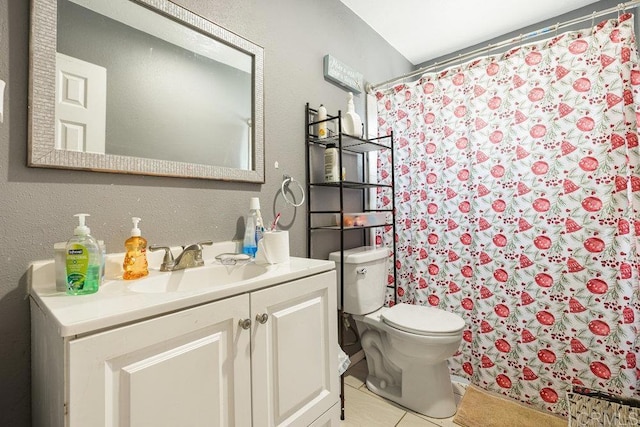 bathroom featuring a shower with shower curtain, vanity, toilet, and tile patterned flooring