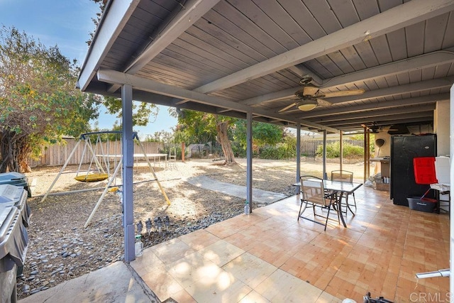 view of patio / terrace featuring a trampoline, a playground, and ceiling fan