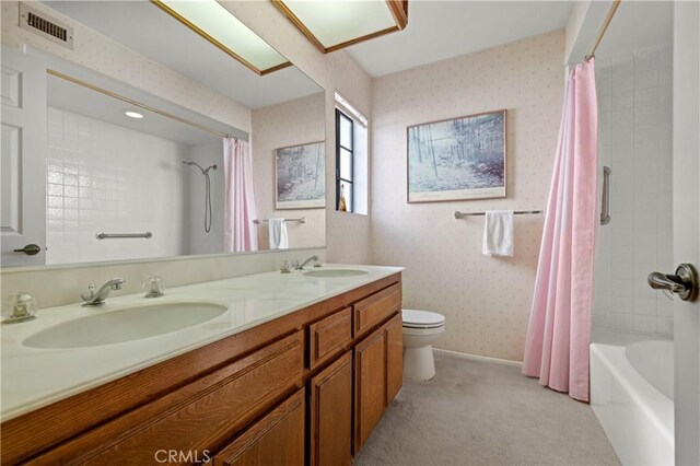 full bathroom featuring vanity, shower / tub combo with curtain, and toilet