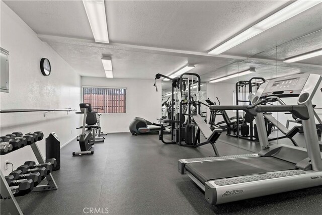 workout area featuring a textured ceiling