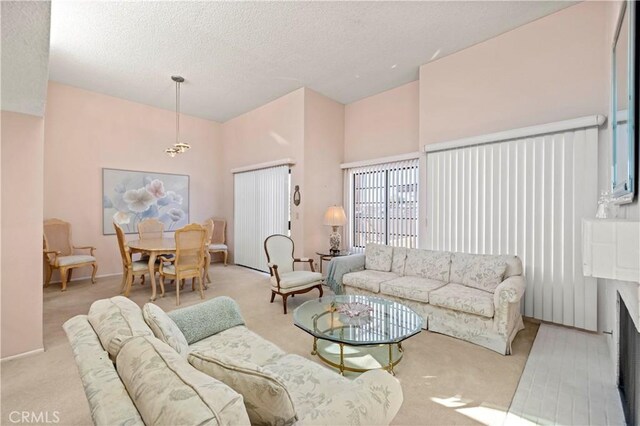 carpeted living room with a textured ceiling