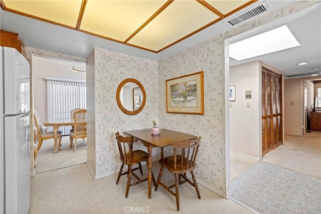 dining room with a skylight