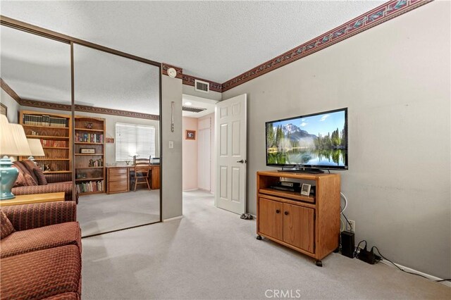 carpeted living room with crown molding and a textured ceiling