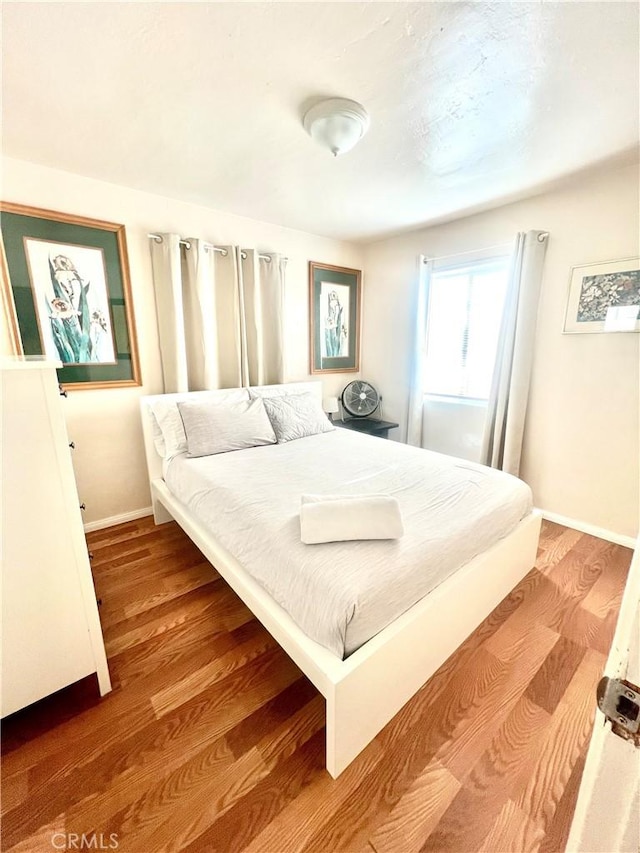 bedroom with hardwood / wood-style flooring