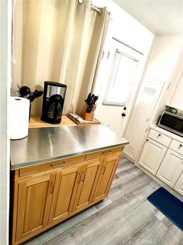 kitchen featuring light wood-type flooring and stainless steel counters