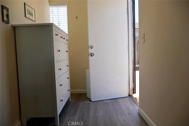 corridor with dark hardwood / wood-style flooring