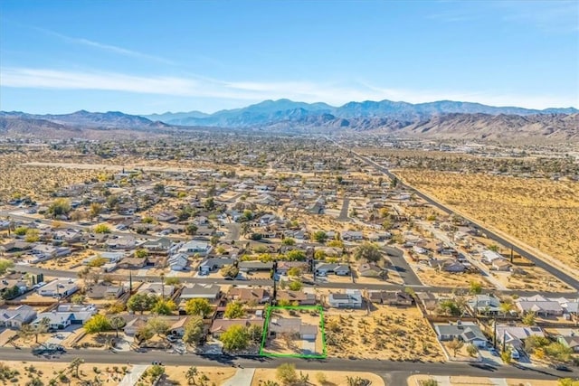 birds eye view of property with a mountain view