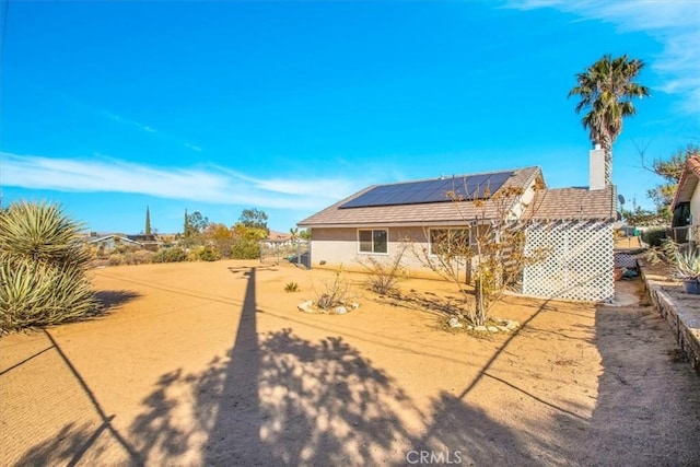 rear view of house with solar panels