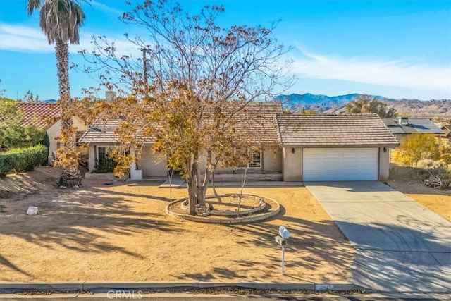 view of front of home with a mountain view and a garage