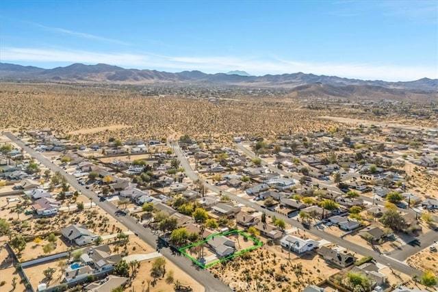 birds eye view of property with a mountain view