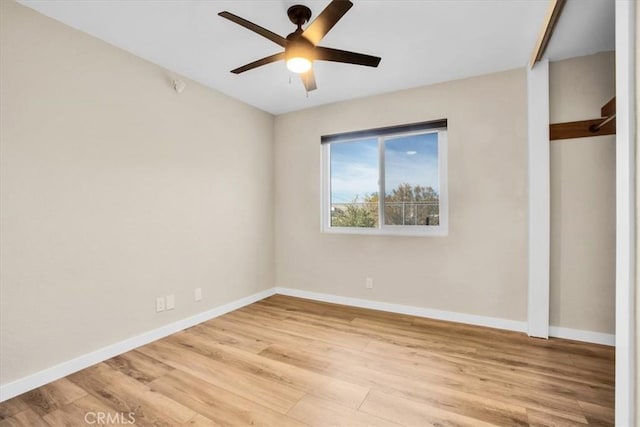 empty room featuring light wood-type flooring and ceiling fan