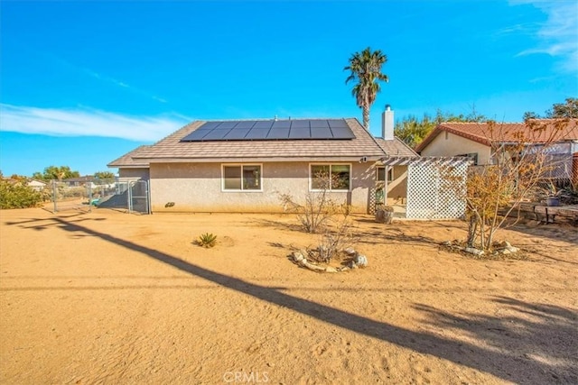 view of front of property featuring solar panels