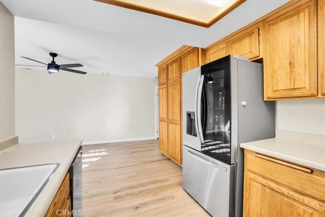 kitchen with ceiling fan, sink, appliances with stainless steel finishes, and light wood-type flooring